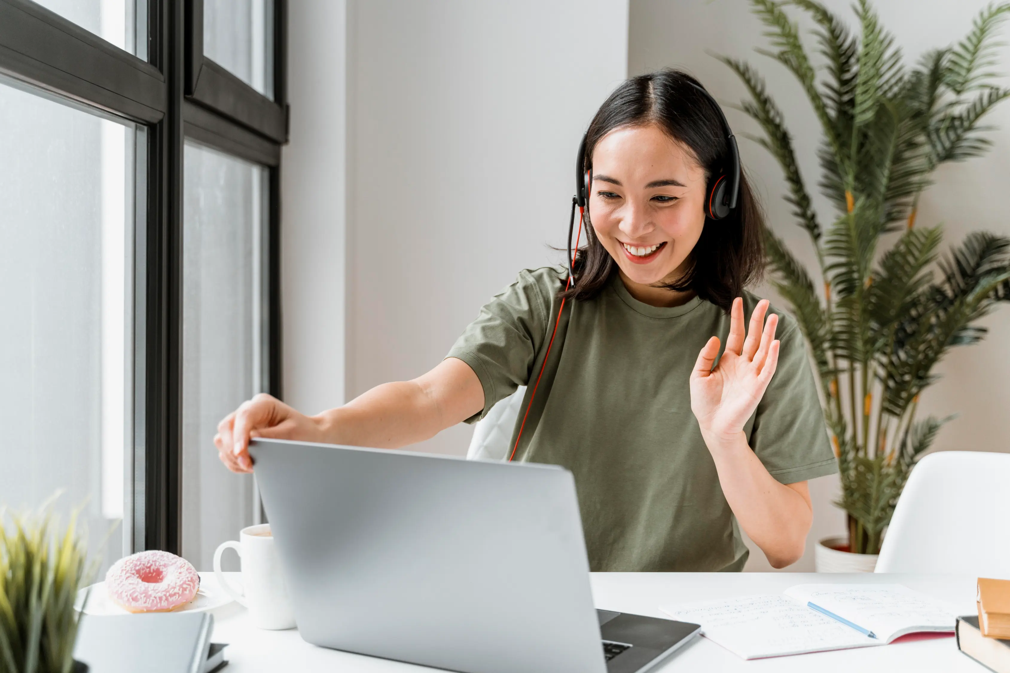 woman with headset having video call laptop